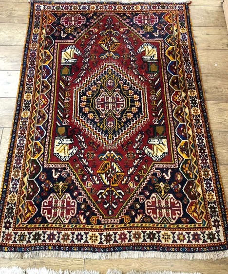 A Turkish red ground prayer rug and two other rugs, 154cm x 108cm, 159cm x 113cm and 149 x 100cm
